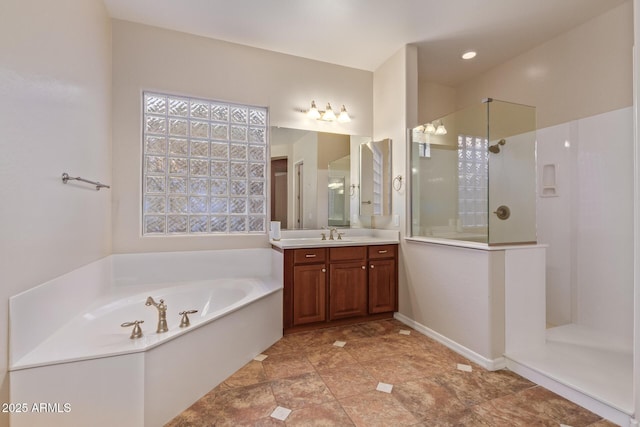 bathroom with a bath, vanity, and walk in shower