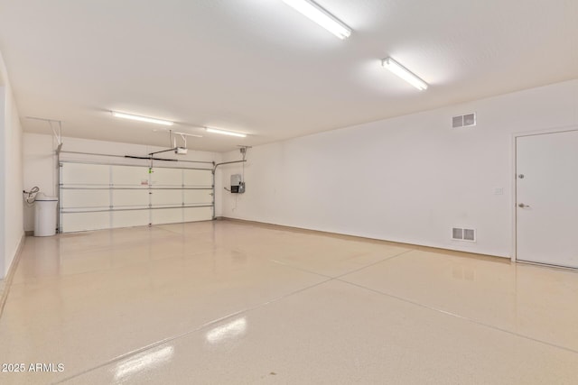 garage featuring visible vents and a garage door opener