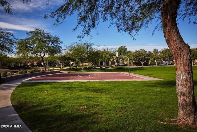 view of basketball court with community basketball court and a yard