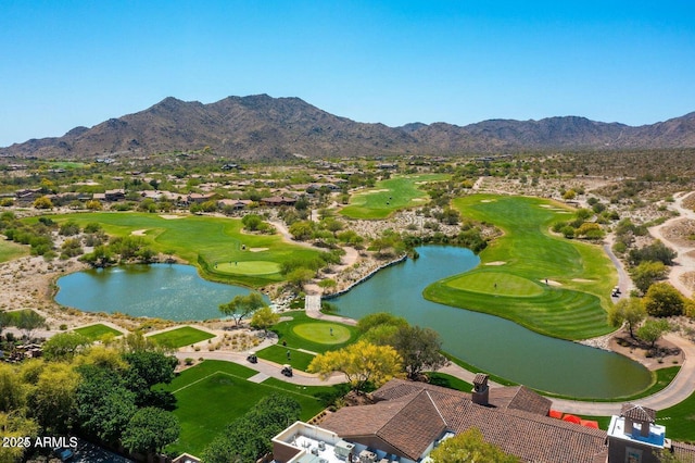 drone / aerial view with golf course view and a water and mountain view