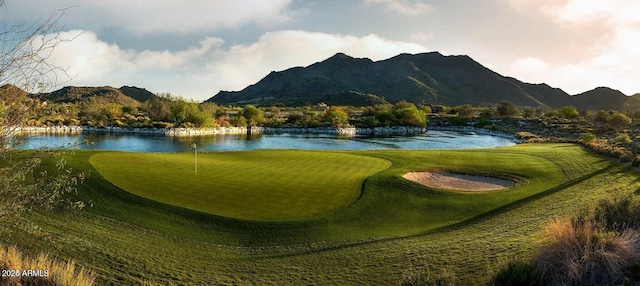 view of home's community with golf course view and a water and mountain view