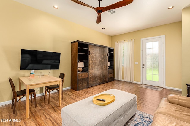 living room featuring hardwood / wood-style flooring and ceiling fan