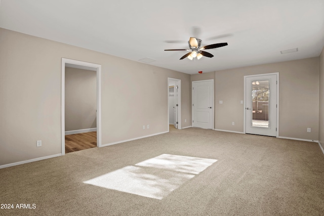 unfurnished bedroom featuring ceiling fan and light carpet