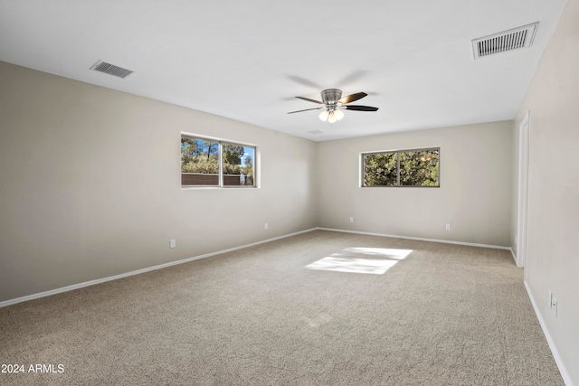 empty room featuring ceiling fan and carpet floors