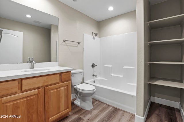 full bathroom featuring wood-type flooring, vanity, shower / bath combination, and toilet