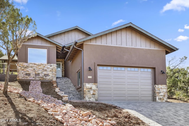 1124 S Sycamore Cir Unit 1, Payson, AZ 85541 - view of front of property featuring stone siding, an attached garage, and decorative driveway