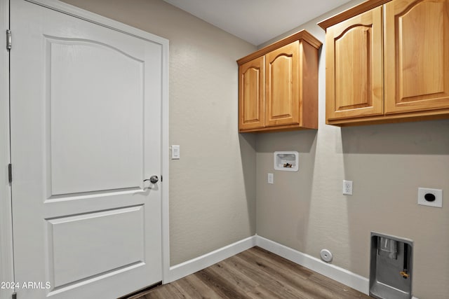 washroom featuring cabinets, washer hookup, gas dryer hookup, electric dryer hookup, and hardwood / wood-style floors