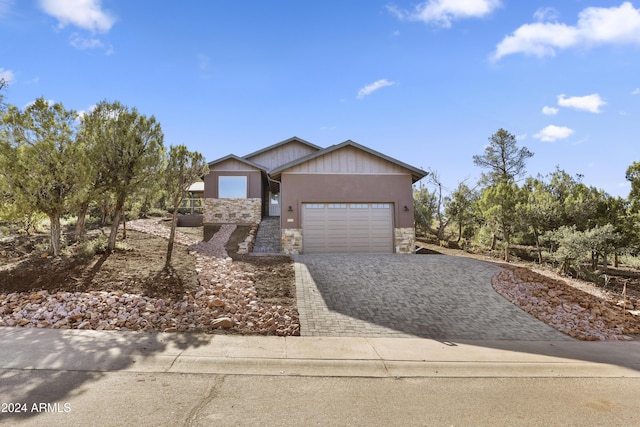 1124 S Sycamore Cir Unit 1, Payson, AZ 85541 - view of front of property featuring stone siding, decorative driveway, an attached garage, and stucco siding