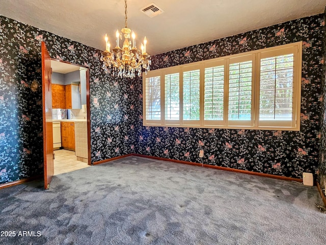unfurnished dining area featuring visible vents and wallpapered walls