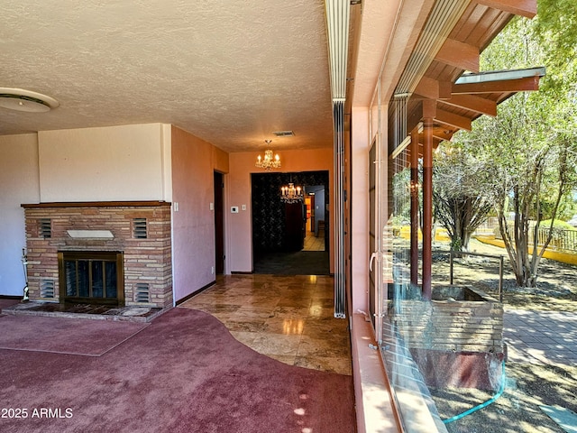 entrance to property featuring stone siding, stucco siding, and visible vents