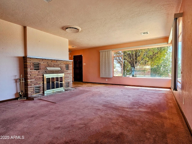 unfurnished living room featuring baseboards, a glass covered fireplace, carpet, and visible vents