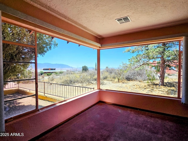 balcony featuring a mountain view and visible vents