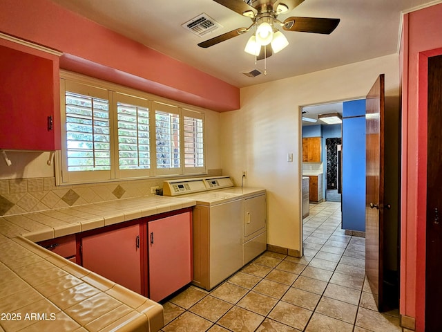 kitchen featuring light tile patterned flooring, visible vents, washer and dryer, and ceiling fan