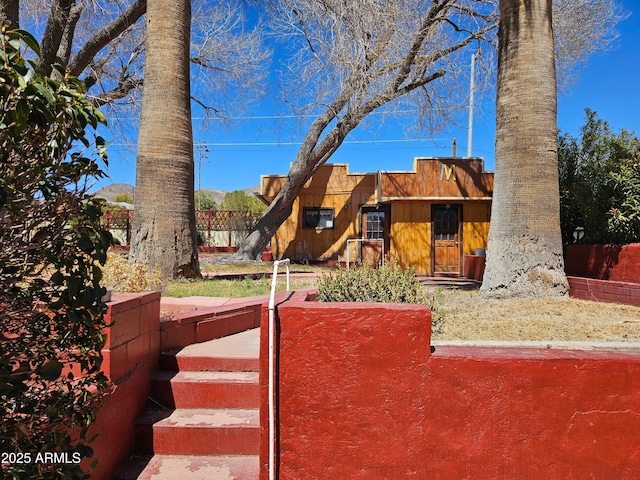view of front of property featuring fence