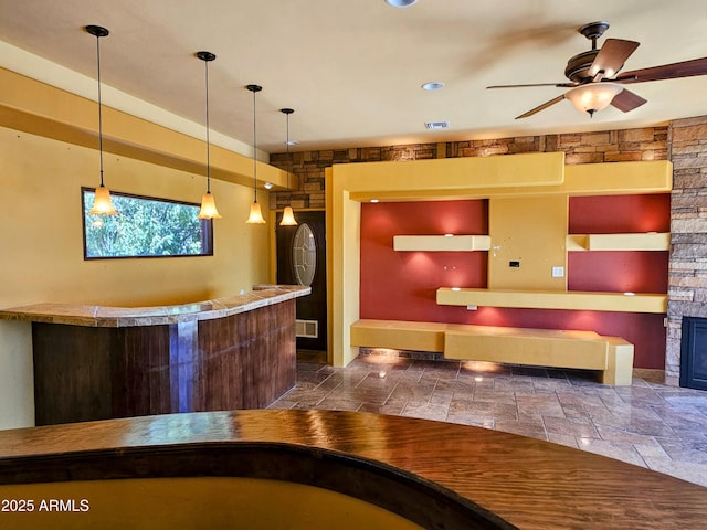 welcome area featuring a community bar, visible vents, and ceiling fan