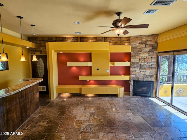 interior space with visible vents, ceiling fan, and a fireplace