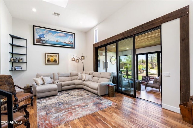 living room with wood-type flooring and french doors