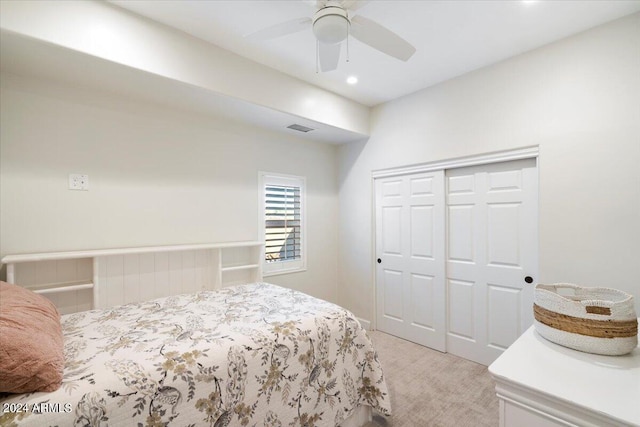 bedroom with light carpet, a closet, and ceiling fan