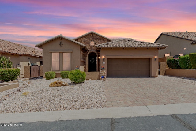 6936 E Snowdon St, Mesa, AZ 85207 - mediterranean / spanish house with a tile roof, stucco siding, a garage, and decorative driveway
