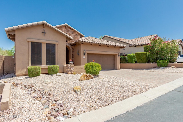 6936 E Snowdon St, Mesa, AZ 85207 - mediterranean / spanish home featuring a tile roof, stucco siding, a garage, and driveway