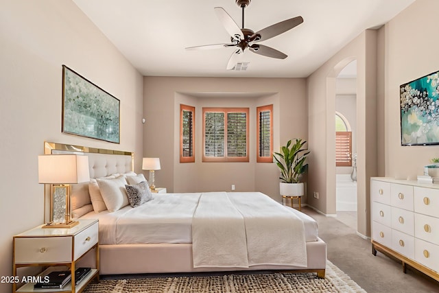 6936 E Snowdon St, Mesa, AZ 85207 - bedroom with carpet flooring, arched walkways, ensuite bath, and ceiling fan