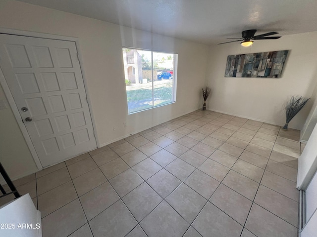 unfurnished dining area with light tile patterned floors and ceiling fan