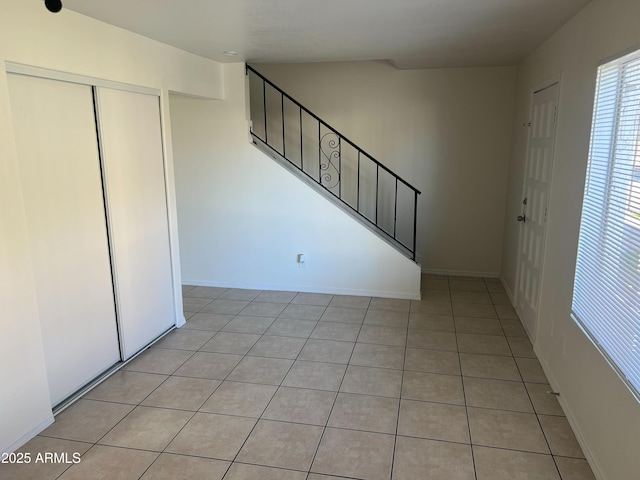 staircase featuring tile patterned floors