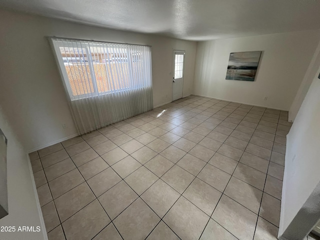 unfurnished room with light tile patterned floors