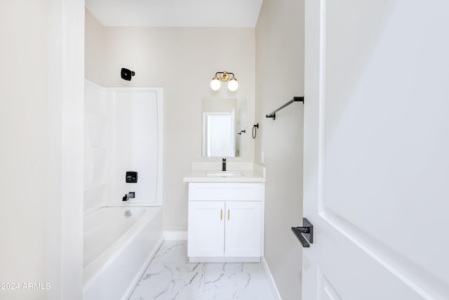 bathroom with baseboards, marble finish floor, shower / washtub combination, and vanity