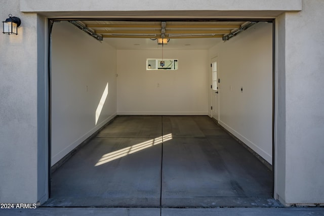 garage with a garage door opener and baseboards