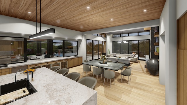 interior space featuring light stone countertops, a high ceiling, hanging light fixtures, light wood-type flooring, and wooden ceiling