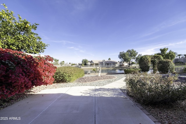 view of community featuring a patio area and a water view