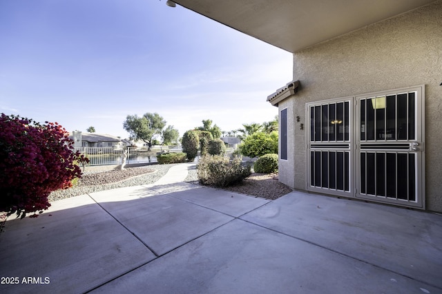 view of patio featuring a water view