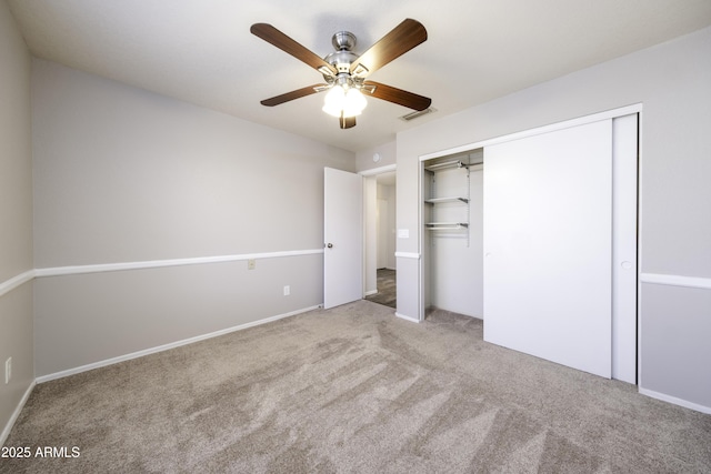 unfurnished bedroom with light carpet, a closet, and ceiling fan