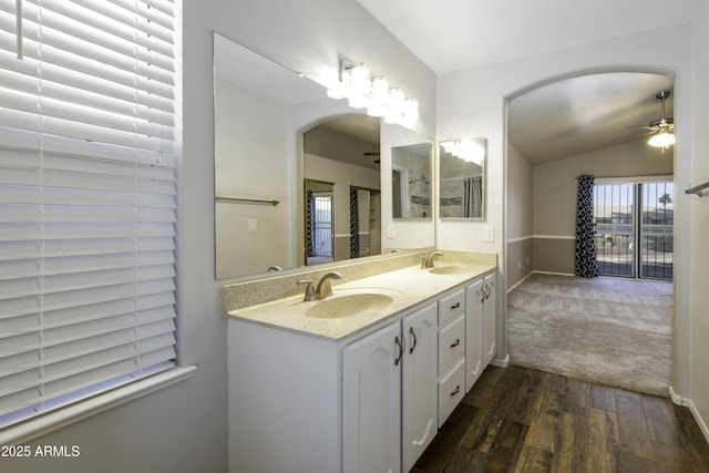 bathroom featuring hardwood / wood-style floors, vanity, ceiling fan, and lofted ceiling