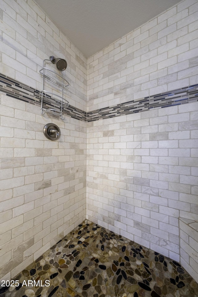 bathroom with tiled shower