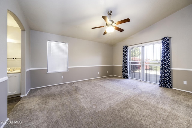 unfurnished room featuring carpet flooring, ceiling fan, lofted ceiling, and sink