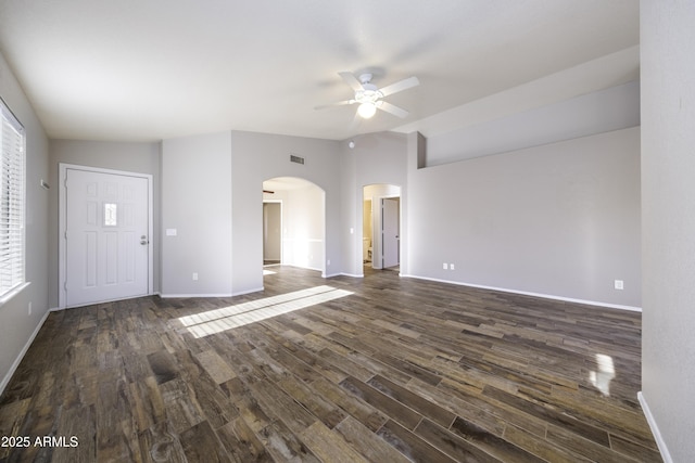 unfurnished living room with ceiling fan, dark wood-type flooring, and lofted ceiling