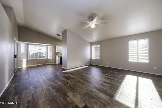 unfurnished living room featuring ceiling fan, dark hardwood / wood-style flooring, and vaulted ceiling