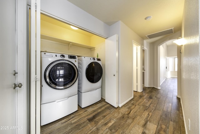 washroom with washer and dryer and dark hardwood / wood-style flooring