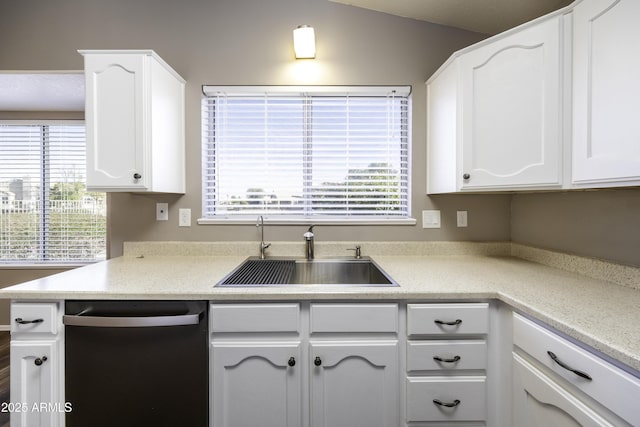 kitchen featuring dishwasher, white cabinetry, lofted ceiling, and sink