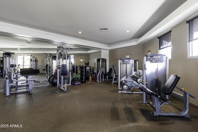 workout area featuring a raised ceiling