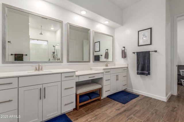 9764 E Thornbush Ave, Mesa, AZ 85212 - bathroom featuring vanity, wood finished floors, a tile shower, recessed lighting, and baseboards