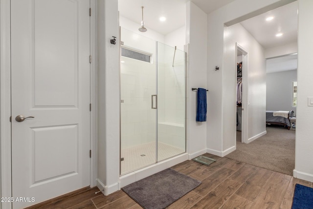 9764 E Thornbush Ave, Mesa, AZ 85212 - full bathroom featuring a stall shower, wood finished floors, baseboards, a spacious closet, and recessed lighting