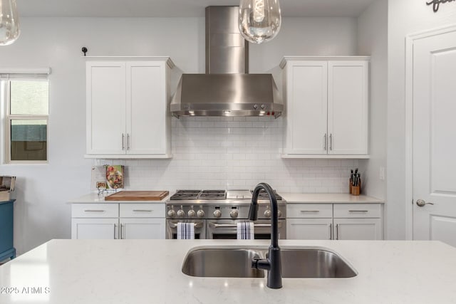 9764 E Thornbush Ave, Mesa, AZ 85212 - kitchen with wall chimney exhaust hood, double oven range, a sink, and white cabinets