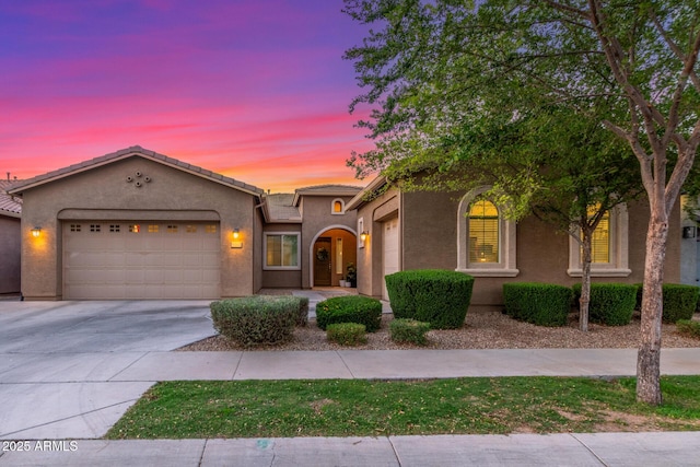 9764 E Thornbush Ave, Mesa, AZ 85212 - view of front of home with an attached garage, driveway, stucco siding, and a tiled roof