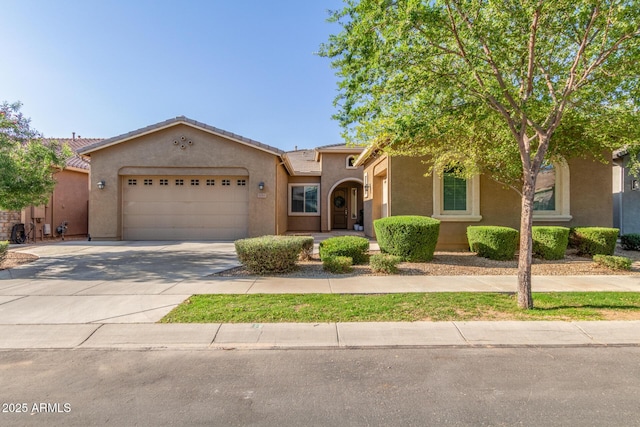 9764 E Thornbush Ave, Mesa, AZ 85212 - view of front of home with an attached garage, stucco siding, concrete driveway, and a tiled roof