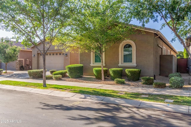 9764 E Thornbush Ave, Mesa, AZ 85212 - view of front facade featuring an attached garage, concrete driveway, and stucco siding