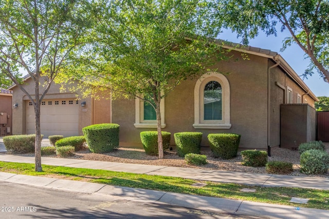 9764 E Thornbush Ave, Mesa, AZ 85212 - view of front facade with an attached garage and stucco siding
