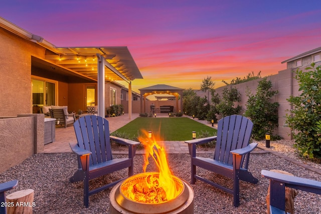 9764 E Thornbush Ave, Mesa, AZ 85212 - fenced backyard with a gazebo, an outdoor living space with a fire pit, and a patio